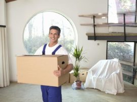 Professional mover carrying a box