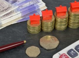 Coins, paper money, and calculator to signify the cost of moving house