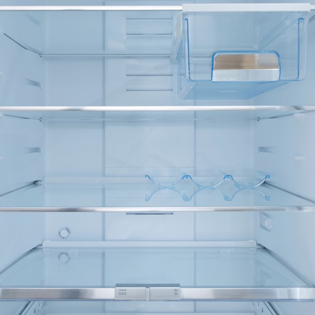 Taking out removable fridge components in preparation for moving a fridge freezer